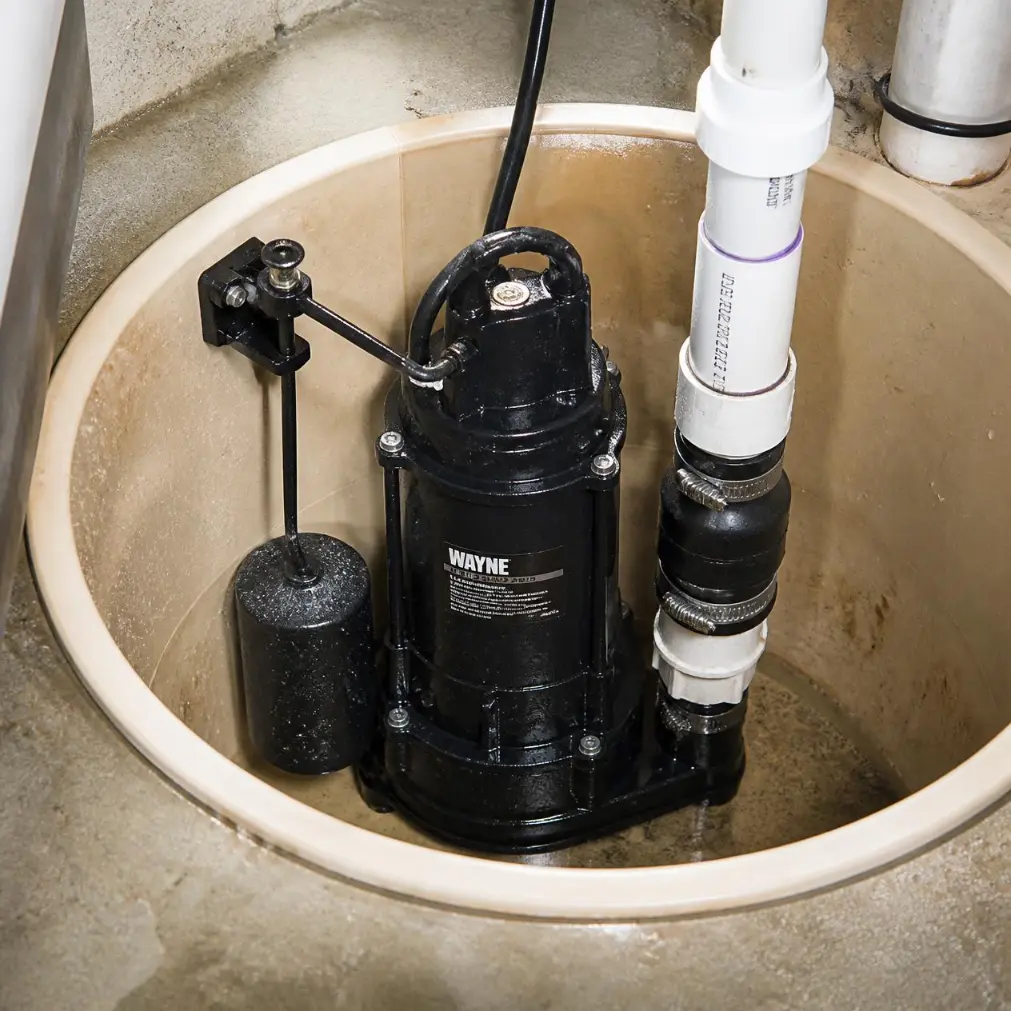 Sump pump with discharge piping and gauges installed in a Naples, Florida home.